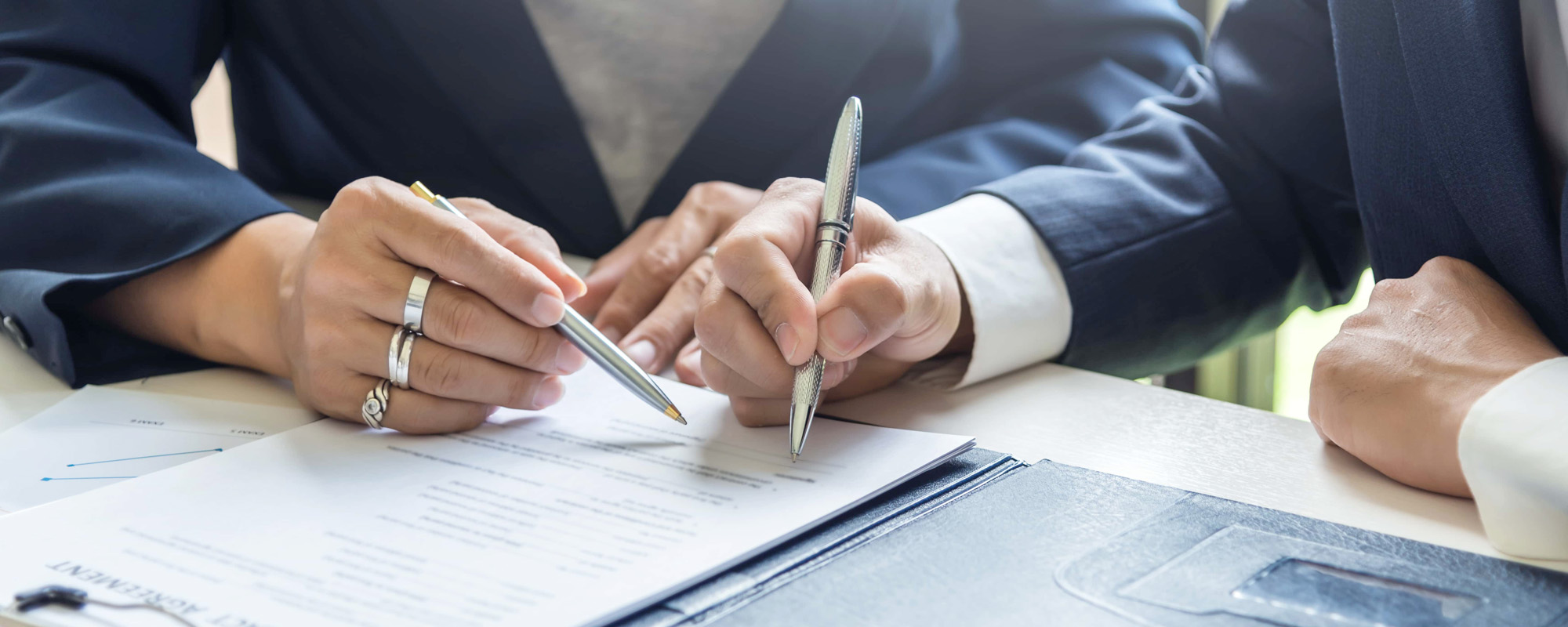 A group of business people sign a joint investment contract