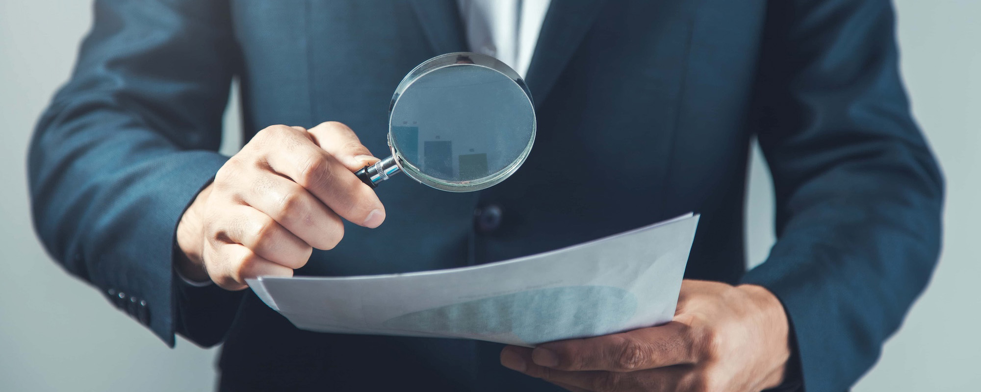 man hand magnifier and document