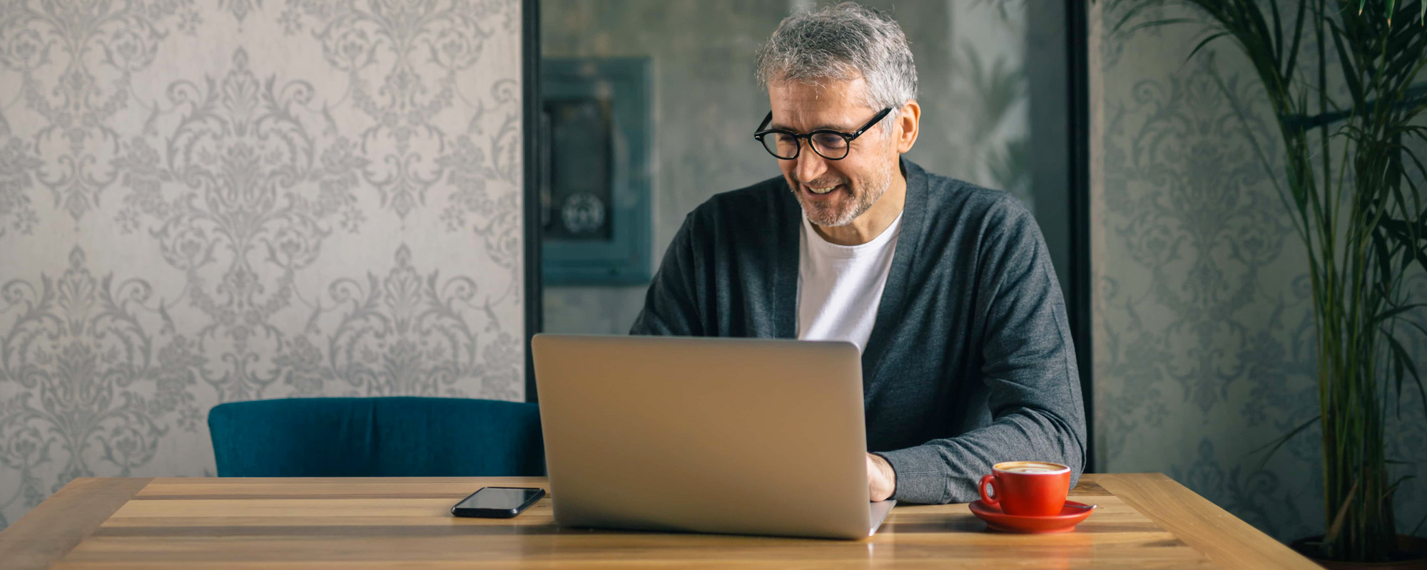 man using laptop in cafe bar