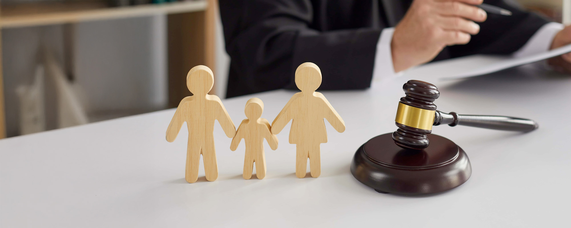 wooden family blocks on desk with gavel and judge