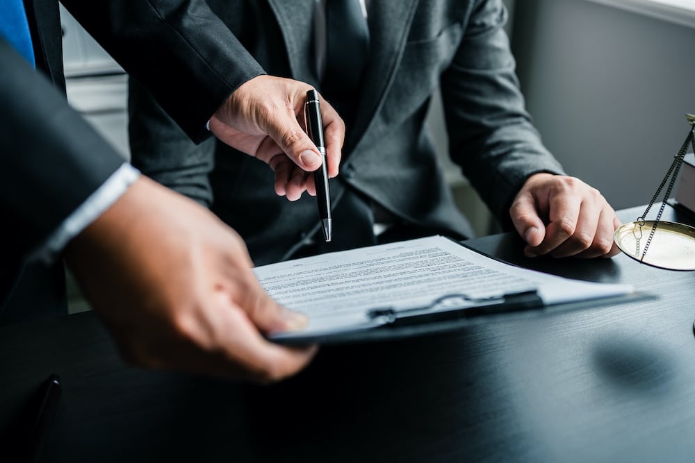 business men signing documents